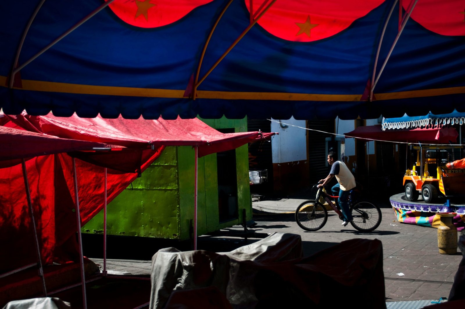 black bicycle parked near green canopy tent during daytime